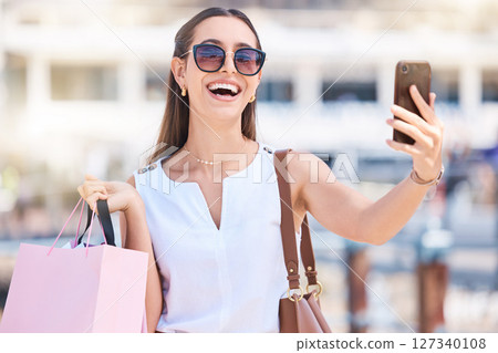 Phone, shopping or woman taking selfie for a social media profile picture in of city of Las Vegas on summer holiday. Fashion, content creator or happy girl influencer smiles with luxury shopping bag 127340108
