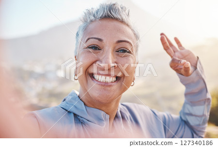 Elderly woman runner, exercise selfie and smile in nature for fitness, wellness or self care with OK hand sign. Happy senior black woman, profile picture and running by mountains, outdoor and workout Elderly woman runner, exercise selfie and smile in nature for fitness, wellness or self care with OK hand sign. Happy senior black woman, profile picture and running by mountains, outdoor and workout 127340186