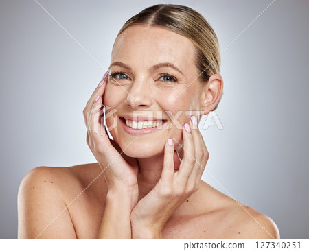 Woman, skincare glow or hands to face on grey studio background for Canada dermatology, healthcare wellness or self care grooming. Portrait, smile or happy beauty model with facial makeup cosmetics Woman, skincare glow or hands to face on grey studio background for Canada dermatology, healthcare wellness or self care grooming. Portrait, smile or happy beauty model with facial makeup cosmetics 127340251