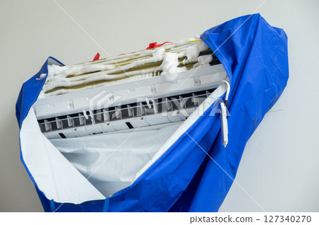 Close up of an air conditioner applying by air conditioner cleaner foam. It can be used with ease to to remove dust and dirt from the air conditioner. 127340270