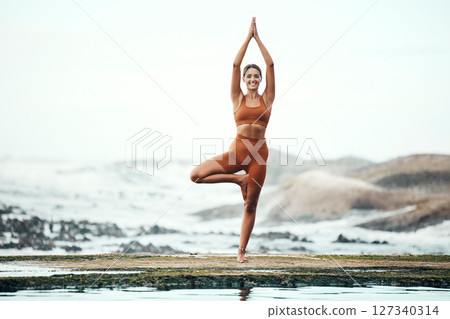 Yoga, woman and stretching on beach, workout or fitness for balance, wellness or health. Female, girl or exercise for training on seaside, zen or practice for performance, healthy or energy for power 127340314