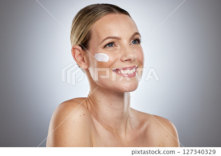 Beauty, skincare and lotion on face of woman for facial, sunscreen or self care routine with cream. Cosmetics, product and luxury with model for moisturizing, anti aging and spa cosmetology in studio Beauty, skincare and lotion on face of woman for facial, sunscreen or self care routine with cream. Cosmetics, product and luxury with model for moisturizing, anti aging and spa cosmetology in studio 127340329