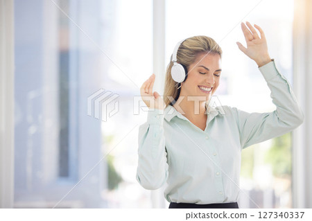 Business woman, headphones and dance in office, relax or celebrate success. Female entrepreneur, ceo and lady with earphones for music, audio or radio for stress relief, dancing or smile in workplace 127340337
