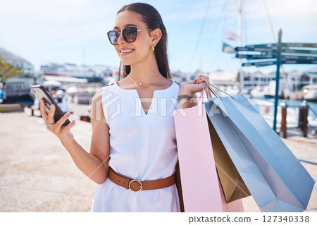 Woman, smartphone and shopping sale, discount and typing for social media, connection and outdoor. Female, customer and shopper with boutique clothes, expensive products and retail for luxury fashion 127340338