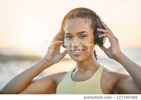 Fitness, music or happy woman at beach for running training, exercise or workout at sunset in Brazil. Portrait, sports athlete or healthy girl runner listening to podcast or radio audio in headphones Fitness, music or happy woman at beach for running training, exercise or workout at sunset in Brazil. Portrait, sports athlete or healthy girl runner listening to podcast or radio audio in headphones 127340366