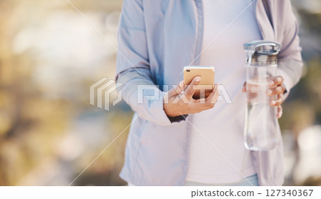 Running, water and phone with hands of woman in mountain for jogging, workout or cardio training. Social media, progress tracker or fitness app with runner on path checking mobile for endurance goals Running, water and phone with hands of woman in mountain for jogging, workout or cardio training. Social media, progress tracker or fitness app with runner on path checking mobile for endurance goals 127340367