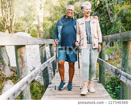 Relax, senior or couple of friends hiking, walking or trekking for freedom, exercise or fitness in nature forest. Interracial, travel or happy woman enjoys bonding time with healthy elderly partner 127340368
