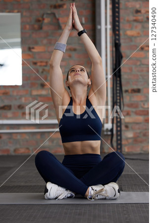 Fitness, yoga or woman stretching in gym for balance, flexible spine or warm up body with healthy breathing. Floor, breathe or zen girl in training, exercise or workout with focus or flexibility 127340490