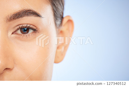 Skincare, beauty and portrait of woman for wellness, dermatology and healthy skin on blue background. Cosmetics, healthcare and face macro of girl on copy space for skincare products, facial and spa 127340512