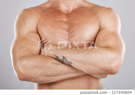 Muscles, man and arms crossed with healthy lifestyle, diet and bodybuilding on grey studio background. Luxury, male bodybuilder or athlete with fitness, chest or body care for power, energy or strong Muscles, man and arms crossed with healthy lifestyle, diet and bodybuilding on grey studio background. Luxury, male bodybuilder or athlete with fitness, chest or body care for power, energy or strong 127340604