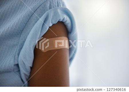 Covid, vaccine and plaster on the arm of a patient in a hospital after a booster shot for cure or treatment. Compliance, corona virus and healthcare with a person in a clinic for security regulations Covid, vaccine and plaster on the arm of a patient in a hospital after a booster shot for cure or treatment. Compliance, corona virus and healthcare with a person in a clinic for security regulations 127340616