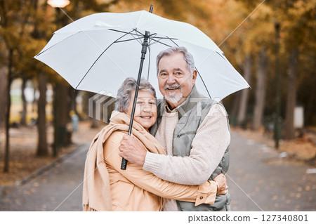 Winter, hug and senior couple in a park, retirement date and walking in Canada with an umbrella. Nature affection, smile and portrait of an elderly man and woman on a walk for happiness and love Winter, hug and senior couple in a park, retirement date and walking in Canada with an umbrella. Nature affection, smile and portrait of an elderly man and woman on a walk for happiness and love 127340801