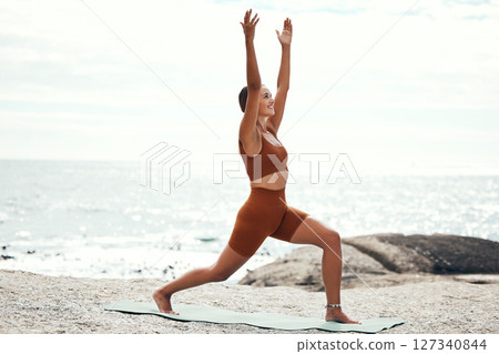 Yoga, balance and fitness with woman at the beach, pilates and zen in nature with exercise and body care outdoor. Workout by the ocean, stretching and peace with mindset and motivation for wellness. Yoga, balance and fitness with woman at the beach, pilates and zen in nature with exercise and body care outdoor. Workout by the ocean, stretching and peace with mindset and motivation for wellness. 127340844