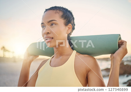 Face, fitness and woman with yoga mat at beach preparing for workout, training or exercise. Zen chakra, meditation and female yogi thinking about pilates for health, wellness and mobility at sunset. Face, fitness and woman with yoga mat at beach preparing for workout, training or exercise. Zen chakra, meditation and female yogi thinking about pilates for health, wellness and mobility at sunset. 127340899
