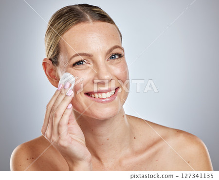 Skincare, cotton and portrait of woman in studio for cleaning, wellness and makeup removal on grey background. Face, skin and girl model with cotton pad for facial, wellness and cosmetic beauty 127341135