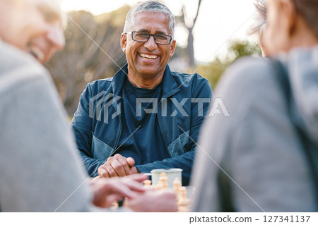 Happy, chess or couple of friends in nature playing a board game, bonding or talking about a funny story. Park, support or healthy senior people laughing at a joke and enjoying quality relaxing time 127341137