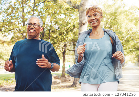Senior runner couple, park and fitness with smile, teamwork or motivation for wellness in summer sunshine. Happy elderly man, woman and running team by trees for exercise, health or outdoor workout 127341256