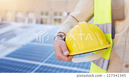 Engineering, solar energy or hand with helmet for safety while working on photovoltaic development project. Industry hat, solar panels or construction worker working on building rooftop maintenance Engineering, solar energy or hand with helmet for safety while working on photovoltaic development project. Industry hat, solar panels or construction worker working on building rooftop maintenance 127341345
