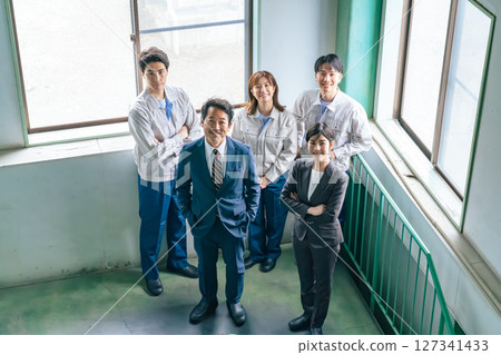 A group of company employees lined up indoors 127341433