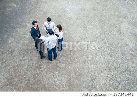 Group of office workers gathered outdoors to talk Group of office workers gathered outdoors to talk 127341441