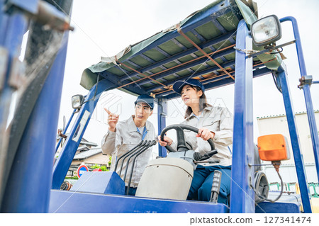 Group of workers operating a forklift 127341474