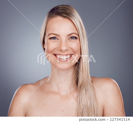 Portrait, beauty and hair with a model woman in studio on a gray background for keratin treatment or natural haircare. Face, skincare and wellness with a female posing to promote a haircare product 127341514