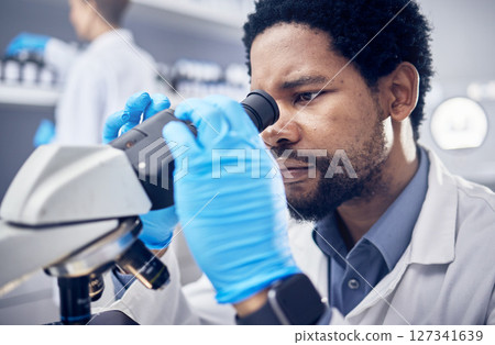 Black man, scientist and microscope with science research in laboratory, data analysis and expert with scientific or medical innovation. Phd doctor, face and biotechnology, chemistry and study in lab 127341639