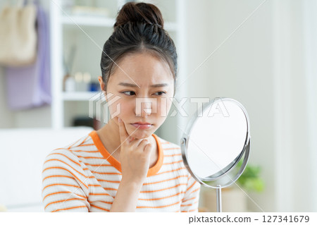 Young woman suffering from skin 127341679