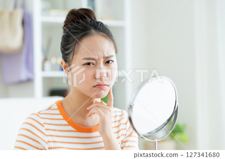 Young woman suffering from skin 127341680