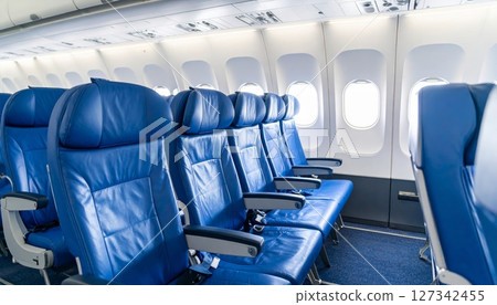 Empty chairs in a row inside an airport or train for business travel Empty chairs in a row inside an airport or train for business travel 127342455