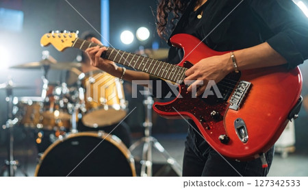 Guitarist playing rock music on an electric instrument 127342533