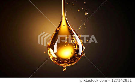 Golden oil drops falling on a dark background. 127342931