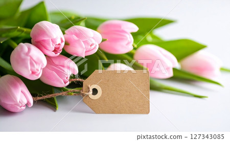 A fresh spring bouquet of pink tulips on a wooden background, perfect for a special gift or holiday 127343085