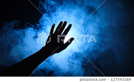 hand reaching through the dark blue light 127343169