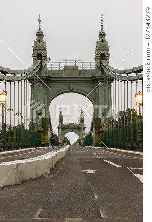 View of Hammersmith Bridge is a suspension bridge that crosses the River Thames in west London. View of Hammersmith Bridge is a suspension bridge that crosses the River Thames in west London. 127343279
