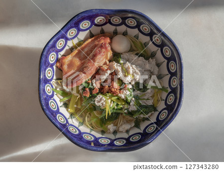 Egg noodles soup served with Crispy pork belly, Fish balls, Minced pork, Cantonese kale. 127343280