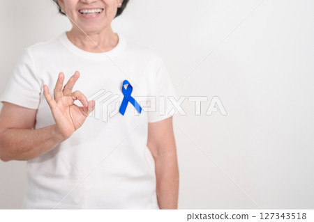 Elderly with dark Blue or Navy blue Ribbon for concept of March Colorectal and Colon Cancer Awareness month, May Arthritis awareness, July Juvenile arthritis and Childhood. Health and world cancer day Elderly with dark Blue or Navy blue Ribbon for concept of March Colorectal and Colon Cancer Awareness month, May Arthritis awareness, July Juvenile arthritis and Childhood. Health and world cancer day 127343518