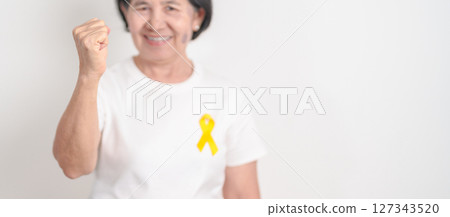 Elderly with Yellow Ribbon for concept of yellow September, Suicide prevention day, Childhood, July Sarcoma, bone cancer Awareness in children month, support survivor. Healthcare and World Cancer day 127343520