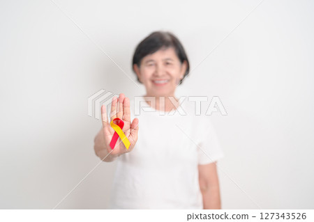World hepatitis day awareness month, 28 July. elderly woman with Red and Yellow ribbon. Liver cancer, Jaundice, Cirrhosis, Failure, Enlarged, Hepatic Encephalopathy and Health concept 127343526