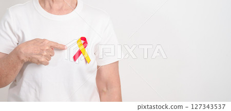 World hepatitis day awareness month, 28 July. elderly woman with Red and Yellow ribbon. Liver cancer, Jaundice, Cirrhosis, Failure, Enlarged, Hepatic Encephalopathy and Health concept 127343537