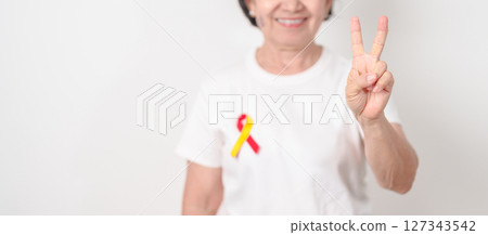 World hepatitis day awareness month, 28 July. elderly woman with Red and Yellow ribbon. Liver cancer, Jaundice, Cirrhosis, Failure, Enlarged, Hepatic Encephalopathy and Health concept 127343542
