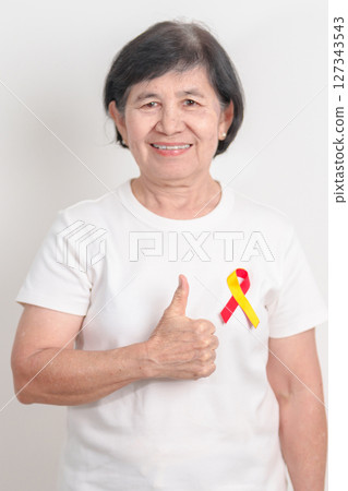 World hepatitis day awareness month, 28 July. elderly woman with Red and Yellow ribbon. Liver cancer, Jaundice, Cirrhosis, Failure, Enlarged, Hepatic Encephalopathy and Health concept 127343543