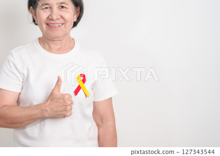 World hepatitis day awareness month, 28 July. elderly woman with Red and Yellow ribbon. Liver cancer, Jaundice, Cirrhosis, Failure, Enlarged, Hepatic Encephalopathy and Health concept 127343544