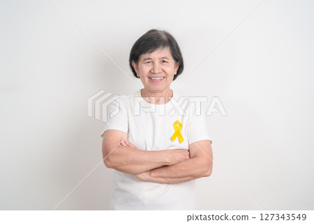 Elderly with Yellow Ribbon for concept of yellow September, Suicide prevention day, Childhood, July Sarcoma, bone cancer Awareness in children month, support survivor. Healthcare and World Cancer day Elderly with Yellow Ribbon for concept of yellow September, Suicide prevention day, Childhood, July Sarcoma, bone cancer Awareness in children month, support survivor. Healthcare and World Cancer day 127343549