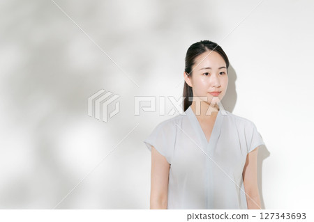 A woman in her twenties smiling in the summer sunshine 127343693