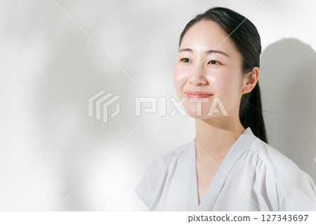 A woman in her twenties smiling in the summer sunshine 127343697