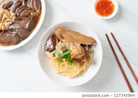 dried noodles with braised duck in white bowl dried noodles with braised duck in white bowl 127343964