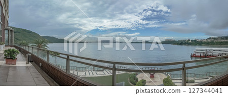 June 13 2025 A small, quiet beach with gentle waves and natural surroundings 127344041