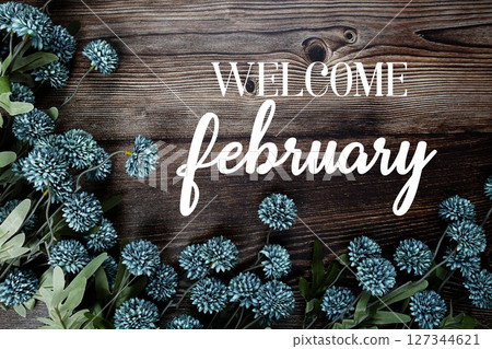 Welcome February text with flowers bouquet decoration on wooden background 127344621