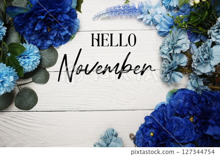 Hello November text with blue flowers bouquet decoration on wooden background 127344754